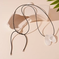Detailed view of silver irregular oval pendants on a black cord necklace against props - Silver Double Oval Necklace