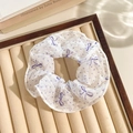 Floral print mesh scrunchie in white and purple dots with bow pattern on beige tray - Purple Polka Dot Bow