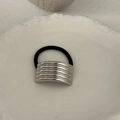 Detail of silver grooved metal cuff on black elastic hair tie for ponytail - Multi-ring Style Silver