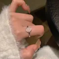 S925 silver ring featuring irregular texture and an oval pink gemstone on finger - Pink Gemstone Style (J3873)