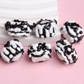 Macro view of handmade black and white glass beads for DIY jewelry on pink background - Mixed White Bead Black White Cream