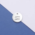 Macro detail of silver mirror-finish stainless steel Aquarius constellation pendant - Aquarius