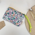 Detailed view of floral canvas makeup pouch with yellow zipper and green woven rope - Purple Floral