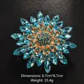 Blue crystal flower brooch with gold base, measuring 6.7cm by 6.7cm and weighing 35.4g - Lake Blue