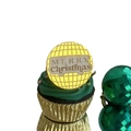 Detail of laser-engraved acrylic Merry Christmas cupcake topper on a green festive cake - Gold Merry Christmas Double Layer