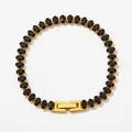 Classic gold tennis bracelet with oval black zircon stones and a secure folding clasp - Black Zirconia Style (SBK086)