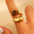 Gold stainless steel wrap ring with tiger eye stone and drop design worn by a model - Tiger Eye Intertwined Shape (S41)