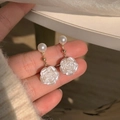Detail of camellia flower earrings with a pearl top and white petals in natural light - No.39 Pearlescent White Rose Pendant