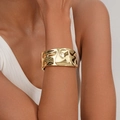 Polished wide gold cuff bangle featuring an irregular hammered texture on a model - Wide Wave Pleated Gold Cuff (SL226) / Gold