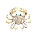 Exaggerated golden crab brooch with colorful AB rhinestones and green gemstone eyes - White