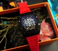 Skeleton tonneau watch with black case and red silicone strap on display - Black Case Red Strap