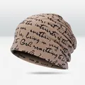 Trendy khaki slouchy beanie with black script lettering for street style fashion wear - All-over Script Print Style / Khaki