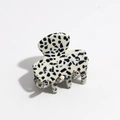 Detail of a spotted marble patterns on a polished cream acetate hair claw clip - Dotted Black White