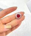 Close-up of a heart pendant with a faceted red stone and white gems in silver base - Silver & Red