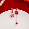 Detail of red bead earrings with lion dance and Fu character symbols for New Year - Lion Dance Fu Asymmetric