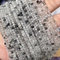 Faceted natural black rutilated quartz small beads showing clear needles on hand - Black Rutilated Quartz 3mm