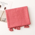 Detail of coral cotton scarf with subtle glitter shimmer and tassel edge trim - Watermelon red