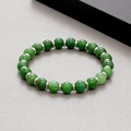Elastic green agate bead bracelet with silver spacers on grey textured background - Emerald Green Natural Stone (KB183241-TLX)