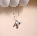 Macro shot of silver letter K balloon style pendant with polished finish on box chain - Silver (With Necklace) K