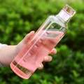 Pink gradient water bottle with time markers and capacity indicators held in hand - 500ml / Gradient Pink