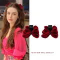Mini burgundy velvet bow hair claw clips for bangs and side hair styling on a model - Burgundy