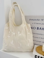 Detailed cream white tote bag with floral embroidery and textured fabric in a cozy setting - Beige Leaf Embroidery