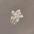 Golden five-petal flower hair claw with clear marquise crystals and blue center stone - Crystal Flower