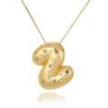Macro detail of gold-plated pendant with sparkling cubic zirconia on white reflective base - Letter Z