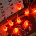Christmas LED string lights with red Santa Claus shapes and artificial snow decor - Santa Claus