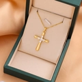 Elegant gold cross necklace with clear zircon inlays displayed on a jewelry box - 9208 / Gold