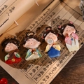 Set of four resin Tang dynasty lady figurines with traditional instruments on vintage book - Set of Four Fridge Magnets