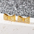 Boucles d'oreilles papillon dorées avec pierres transparentes sur pierre blanche - Noeud en Zirconium