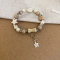 Beaded bow bracelet with star charm and vintage aesthetic on textured fabric background - Light Coffee-Star Smiley