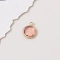 Pink 10mm round crystal birthstone pendant with gold frame and top jump ring - Champagne