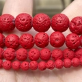 Red volcanic lava stone beads in various sizes for jewelry making shown on palm - Matte Red Lava Stone