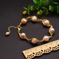 Handmade light pink pearl bracelet wrapped in gold wire with extension chain - Purple Spherical Wire Wrapped Bracelet
