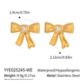 Detail view of gold bow earrings with heart zircon and size measurements - White Heart Gemstone Gold Bow Style (YYE025245-WE)