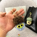 Close-up of blue plush cauliflower keychain with glasses and brown hair detail - Single OPP Bag Packaging / Haze Blue