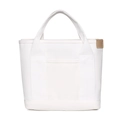 Detailed macro of white canvas tote bag with brown leather label on plain white background - White