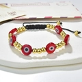 Detailed close-up of a red evil eye bead bracelet with gold accents on a black woven cord - Red Evil Eye Style (221025G-D-5)