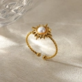 Detail of twisted gold ring band with sun design and pearl center on textured surface - Sun Shape Artificial Pearl Style (G11117203)