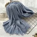 Blue-grey wrinkled scarf with raw fringe edges displayed in a woven basket - Haze Blue