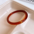 Detailed view of a translucent reddish-brown resin bangle with glossy jelly-like texture - No. 30 Brown-Red Jelly Texture (No. 30 Bangle - Amber)