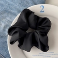 Elegant black lace scrunchie with pleated matte fabric on a decorative ceramic plate - High Satin Black
