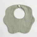 Macro detail of soft sage green flower-shaped muslin cotton baby bib with snap button - Grass Green
