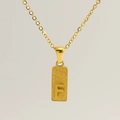 Detailed macro view of rectangular gold pendant with an engraved capital letter F - Letter F