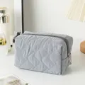 Quilted gray makeup bag with diamond stitching and smooth zipper closure for travel - Irregular Quilted Grey