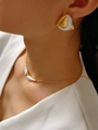 Detail showing the vintage-style 18K gold and white enamel spiral texture earrings - E0918 White Stud Earrings