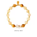 Close-up of strawberry crystal beads with a gold lucky charm and white flower pendant - Light Citrine Cat Eye Lucky Style (WB335)