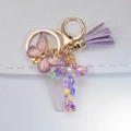 Letter T keychain with purple resin butterfly, matching tassel and golden glitter sequins - Letter T